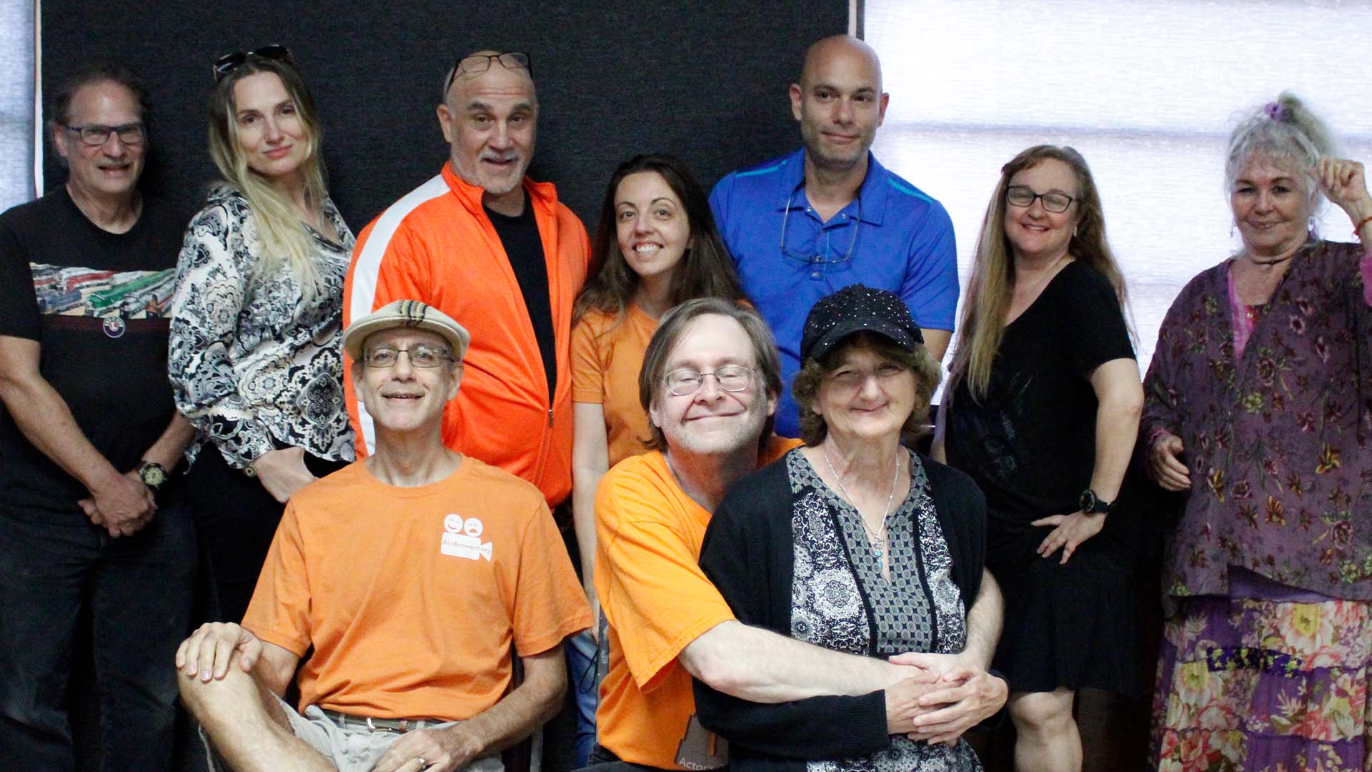 Group of actors smiling.